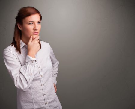 Beautiful young woman thinking with empty copy space