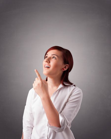 Beautiful young woman standing and thinking with copy space