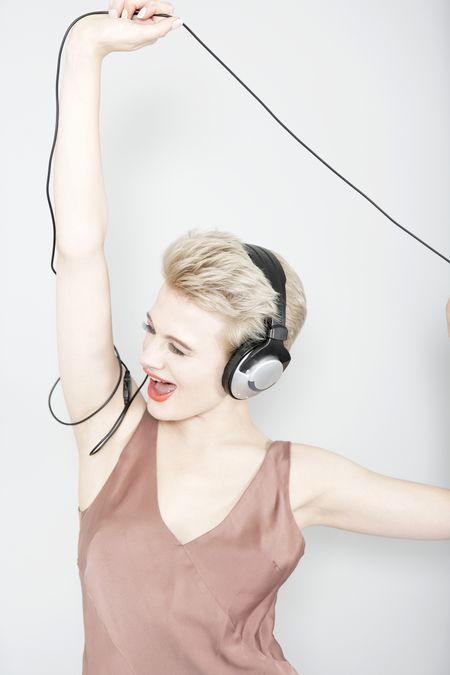 Attractive young woman listening to music through headphones