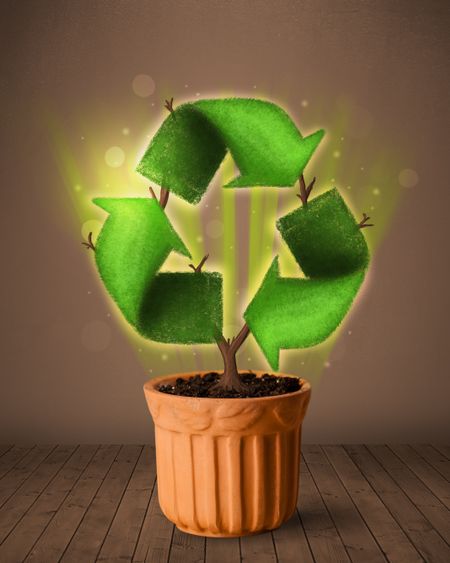 Shining recycle sign growing out of flowerpot concept