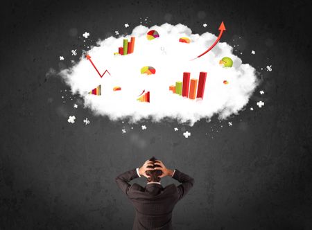 Young businessman standing with colorful charts in a cloud above his head