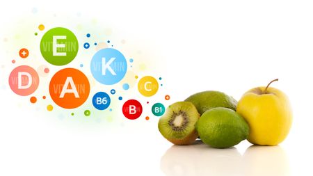 Healthy fruits with colorful vitamin symbols on white background