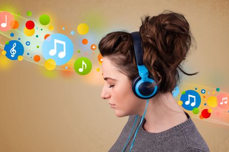 Pretty young woman with headphones listening to music, bubbles concept