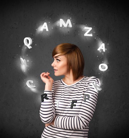 Thoughtful young woman with shining letters circulating around her head