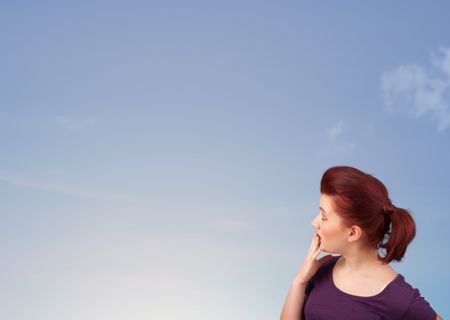 Girl looking at the blue sky copyspace concept
