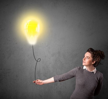 Young woman holding a lightbulb balloon