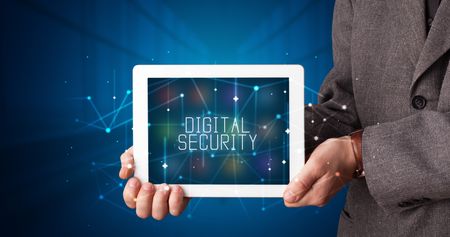 Young business person working on tablet and shows the digital sign: DIGITAL SECURITY