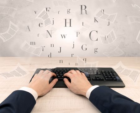 First person view of an elegant businessman hand typing with fluttering papers around