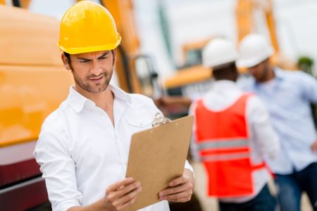 Architect at a construction site checking the project