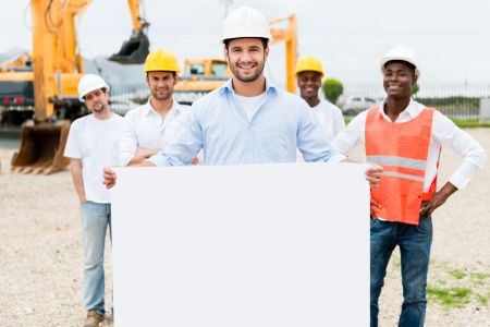 Architect holding a banner at a building site 