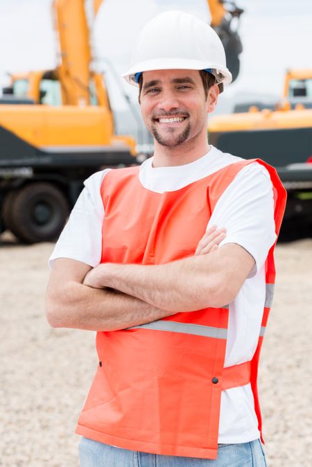 Worker at a building site working with heavy machinery