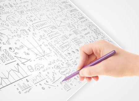 Human hand sketching multiple ideas on a paper