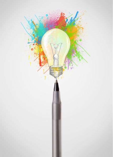 Pen close-up with colored paint splashes and lightbulb concept