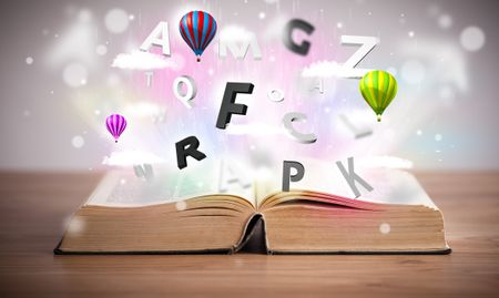 Open book with flying 3d letters on concrete background. Colorful education concept