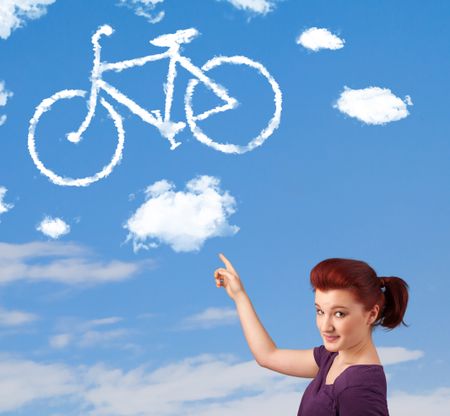 Young casual girl looking at bicycle clouds on blue sky