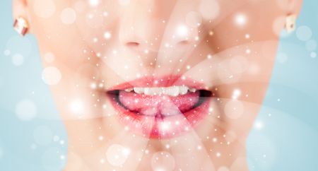 pretty-woman-lips-blowing-abstract-white-150201554 Pretty woman lips blowing abstract white lights - close up