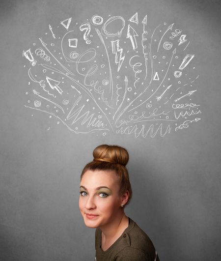 Pretty young woman with many sketched arrows pointed in different directions above her head