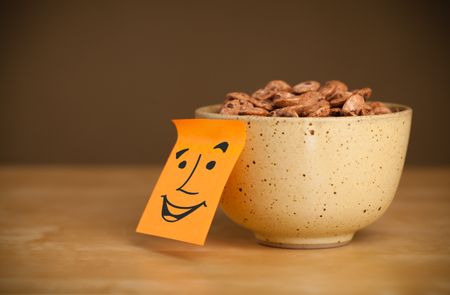 Drawn smiley face on a post-it note sticked on a cereal bowl