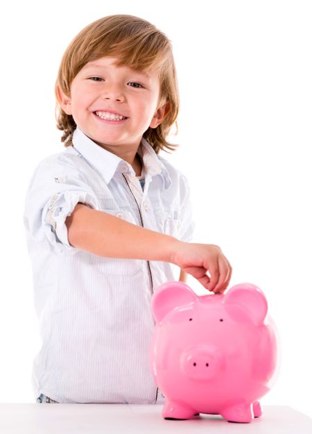 Boy saving money in a piggybank - isolated over white