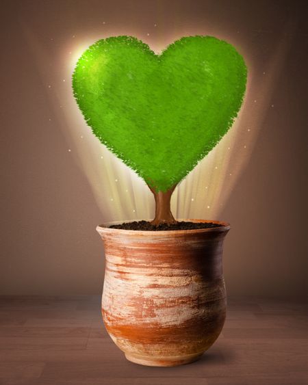 Glowing eco love tree coming out from flowerpot