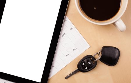 Tablet pc with copy space and a cup of coffee on a wooden work table close-up