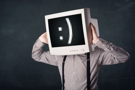 Funny young businessman with a monitor on his head and smiley on the black screen