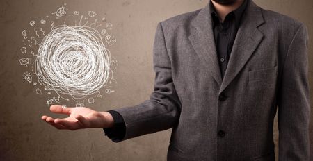 Young businessman holding chaos concept in his hand