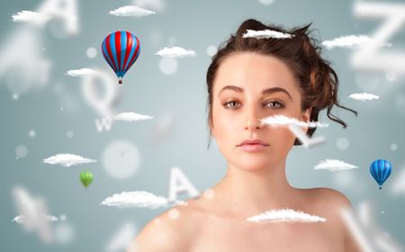 Beautiful young woman with wellness and healthcare clouds on gradient background