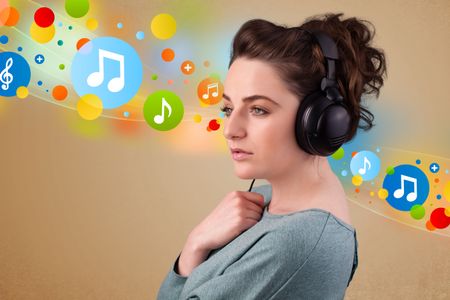 Pretty young woman with headphones listening to music, bubbles concept