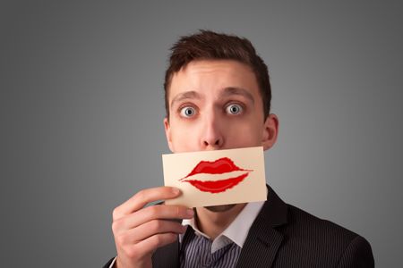 Happy businessman holding funny white card on his mouth with gradient background