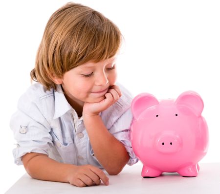 Happy boy with savings in a piggybank - isolated over a white background
