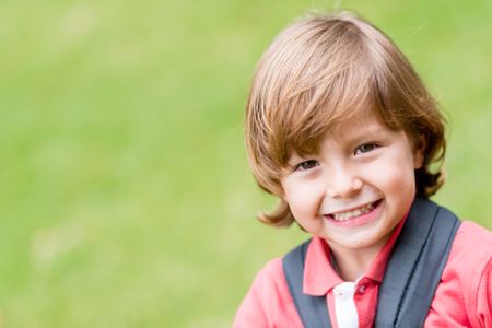 Portrait of a beautiful little boy smiling outdoors