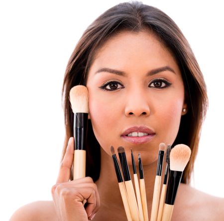 Beautiful woman with make up brushes - isolated over a white background 