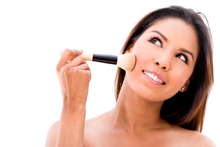 Woman applying makeup with a brush - isolated over white background 