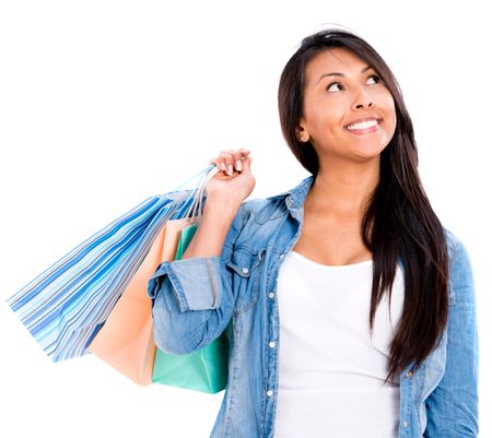 Thoughtful shopping woman holding bags - isolated over white background