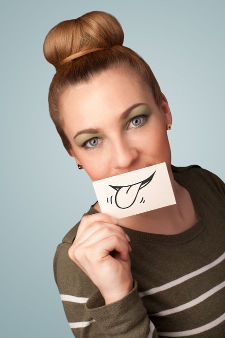 pretty-young-girl-holding-white-card-152046152 Pretty young girl holding white card with smile drawing on gradient background