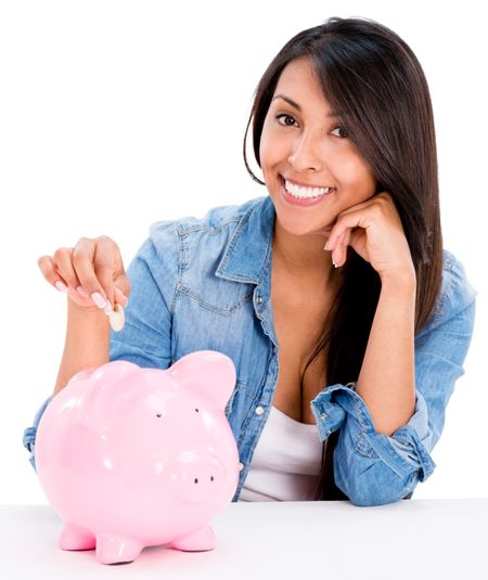 Casual woman saving money in a piggybank - isolated over white background 
