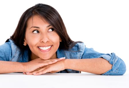 Thoughtful casual woman smiling - isolated over a white background