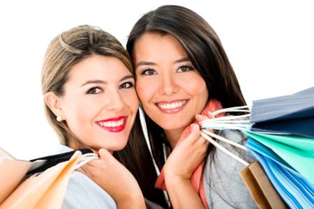 Happy shopping women holding bags - isolated over white background