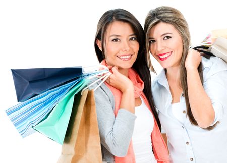 Happy shopping girls holding bags - isolated over white background 