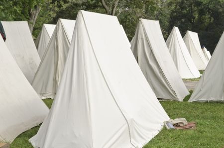 White tents in military encampment at reenactment of American Revolutionary War (1775-1783)