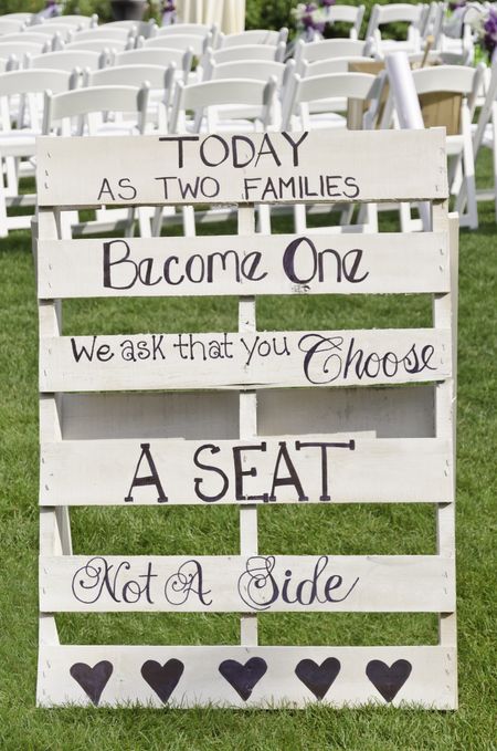 Sign at outdoor wedding: "Today as two families become one we ask that you choose a seat not a side"