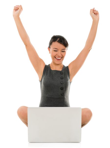 Business woman celebrating her online success - isolated over white 