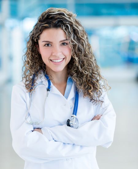 Friendly female doctor smiling at the hospital