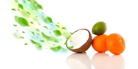 Colorful fruits with green organic leafs on white background