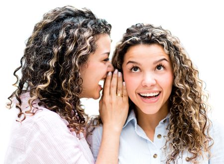 Twins telling a secret - isolated over a white background 