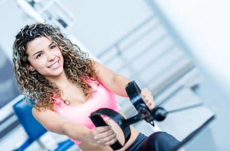 Woman at the gym exercising on a machine