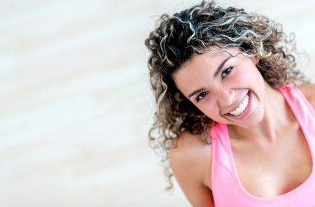 Happy woman portrait at the gym smiling