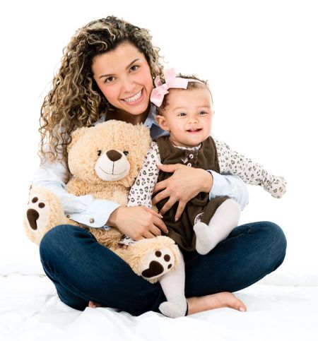 Cute mother and baby with a teddy bear looking happy - isolated over white 