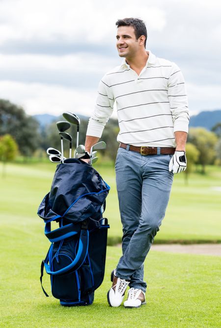 Male golfer at the course with a golf sack 